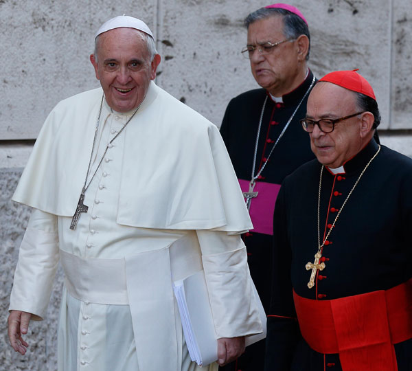 Pope Francis arrives for the concluding business session of the extraordinary Synod of Bishops on the family Oct. 18. Also pictured are Latin Patriarch Fouad Twal of Jerusalem and Cardinal Raymundo Damasceno Assis of Aparecida, Brazil. (CNS/Paul Haring)